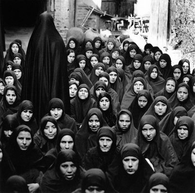 Shirin Neshat, Fervor Series (Crowd of Women, One Leaving), 2000, gelatin silver print. 