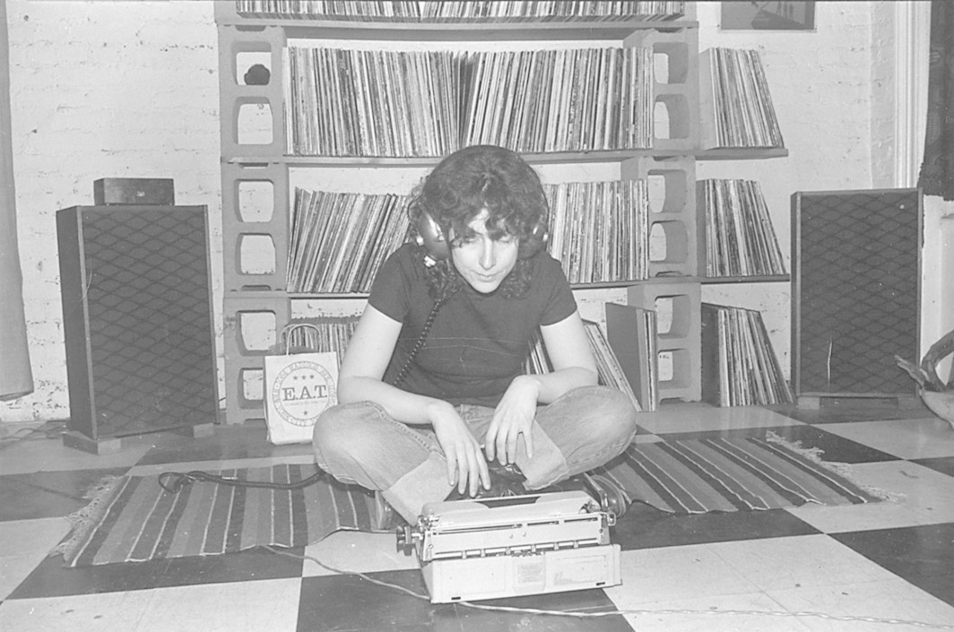 Ellen Willis listening and typing in her apartment on Waverly St., early 80s. Photo from the Ellen WIllis tumblr archive.