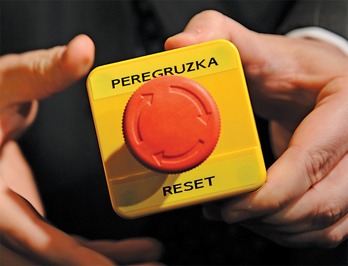 The “reset” button (mistranslated as “overcharge”) presented by Hillary Clinton to Russian foreign minister Sergey Lavrov, March 6, 2009. Reuters/Fabrice Coffrini/Pool/Alamy