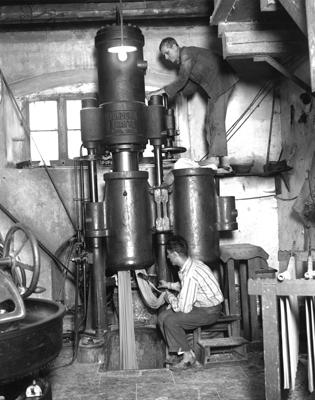 Two men operating a macaroni-making machine, Naples, 1929.