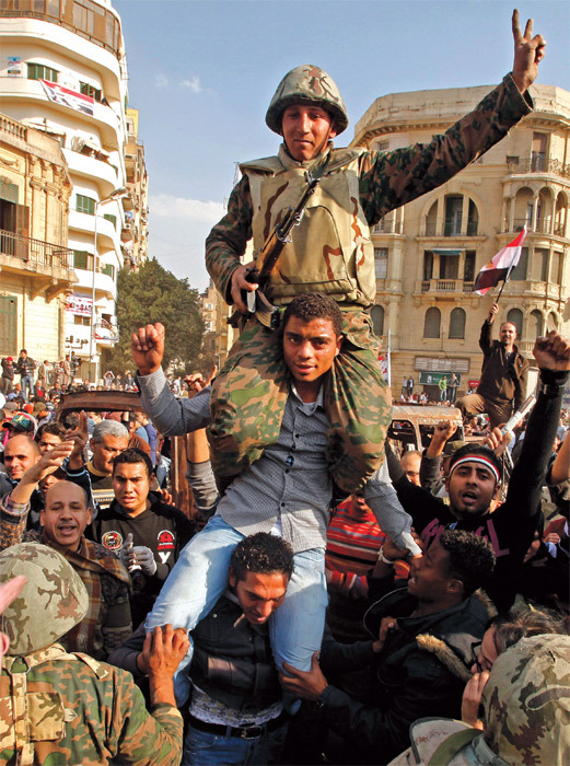 Protesters and soldiers celebrate in Cairo, February 2011. 