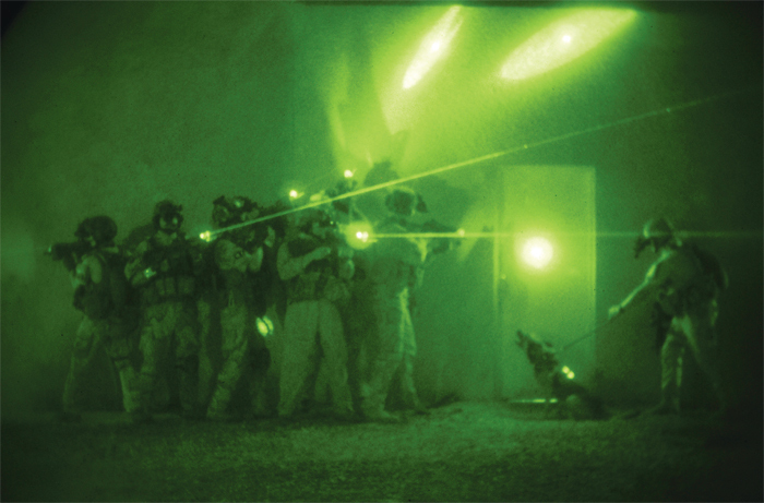 A night-vision photograph of US forces performing a practice operation in Iraq, 2007.