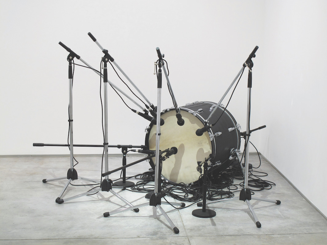 Jamal Cyrus, Untitled (Grand Verbalizer What Time Is It?), 2010, drum, leather, microphones, microphone stands, cables, speaker, dimensions variable. Courtesy the artist, Inman Gallery, Houston and Inventory Press/Collection of Ric Whitney & Tina Perr