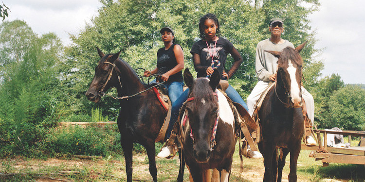 LaToya Ruby Frazier, Zion, Her Mother Shea, and Her Grandfather Mr. Smiley Riding on Their Tennessee Walking Horses, Mares, P.T. (P.T.’s Miss One Of A Kind), Dolly (Secretly), and Blue (Blue’s Royal Threat), Newton, Mississippi, 2017/19, 2021, ink-jet