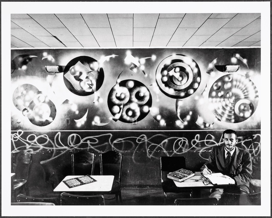Harry Smith with his jazz mural at Jimbo’s Bop City, San Francisco, CA, ca. 1950. Hy Hirsh, courtesy of the Harry Smith Archives.
